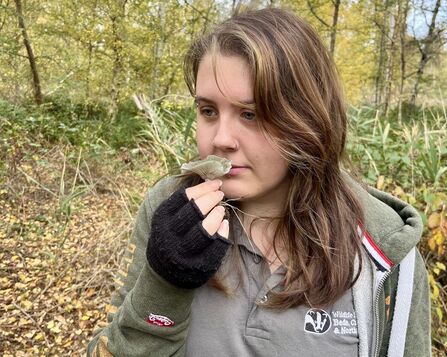 Trainee Kaitlyn is stood in a reserve smelling aniseed funnel